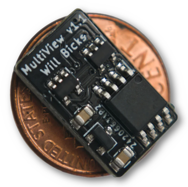 A small black circuit board on a penny.