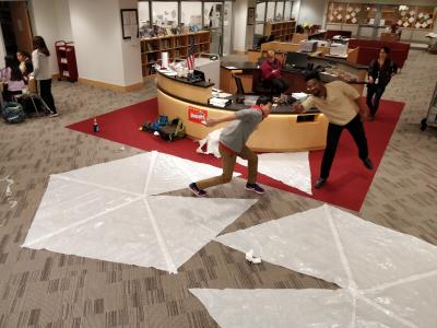 Two white plastic pentagons on the floor of the school library.