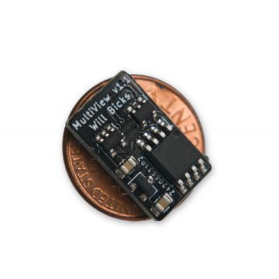 Small black circuit board on top of a penny showing similar size.