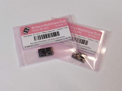 Small black circuit boards in labeled pink bags.