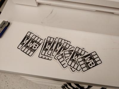 Stickers showing a black and white rendering of the reverse of the circuit board.