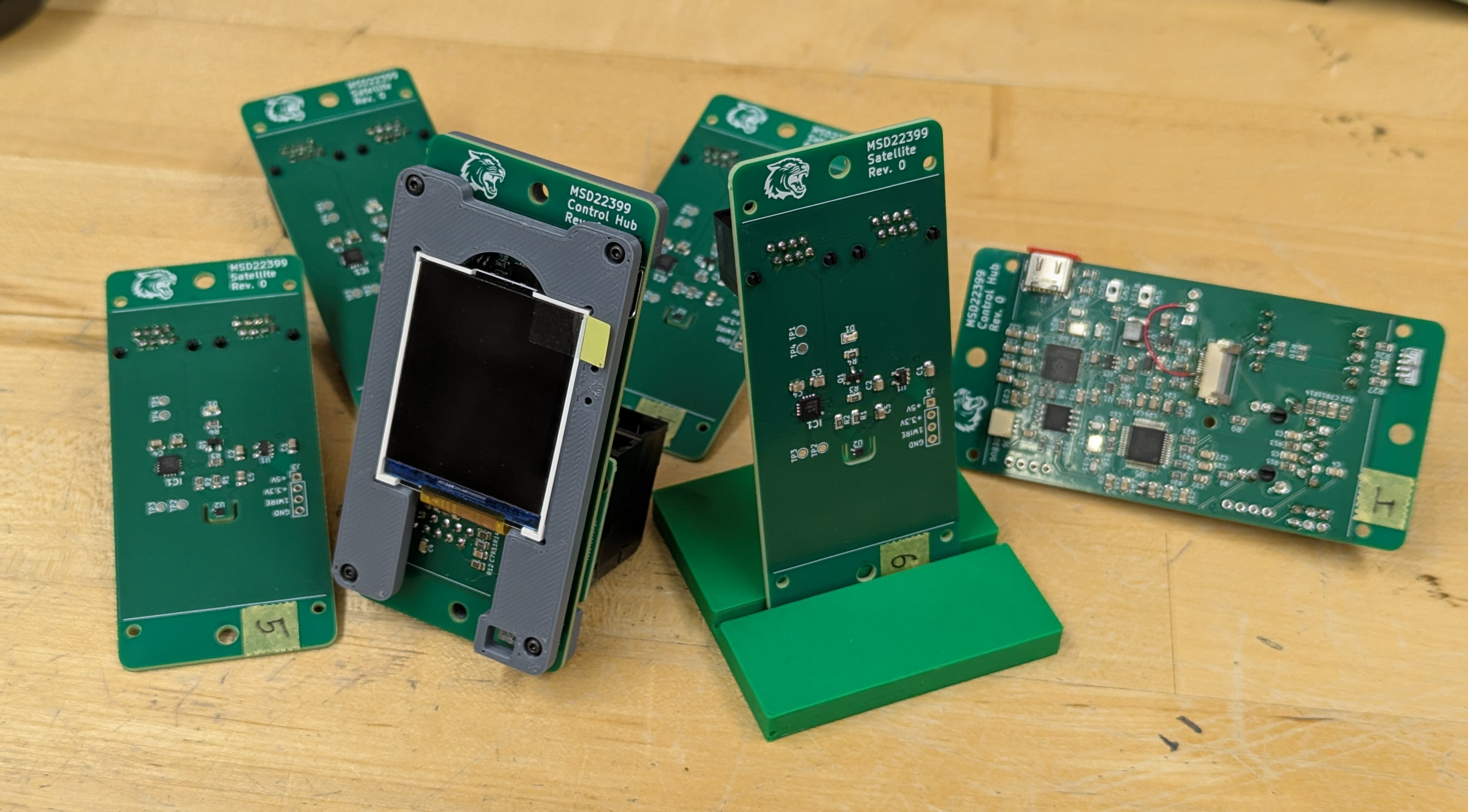 Loose pile of assembled PCBs including control hubs and satellite boards.