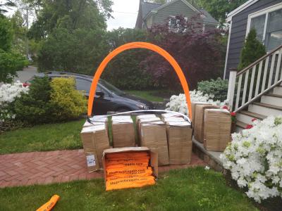 An array of cardboard boxes, with one opened in front, and an expanded gate on top.