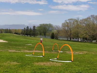 Three practice gates standing in an open field.